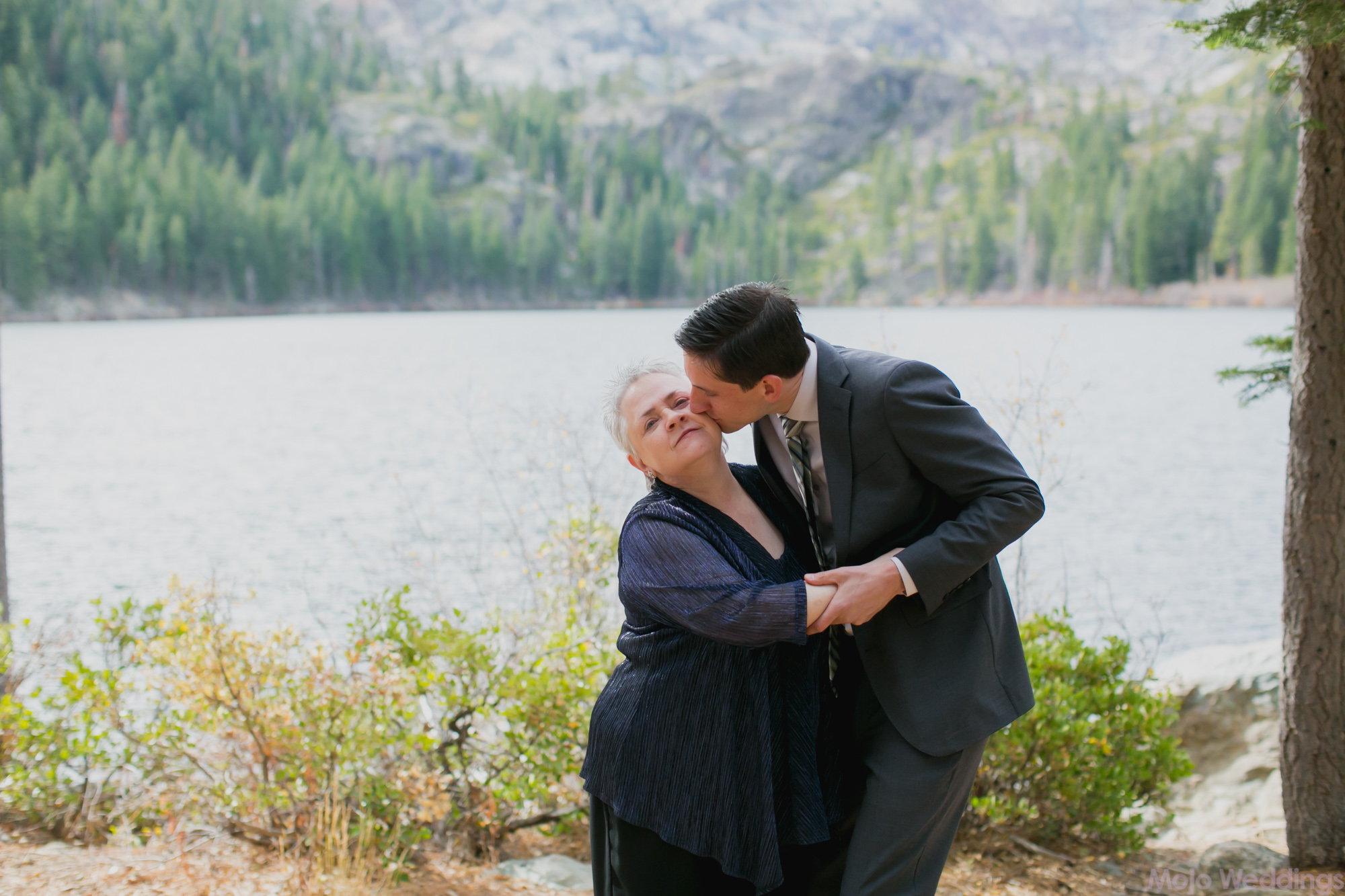 The groom kisses his mother.